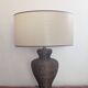 Vintage lamp in brown rattan with textured lampshade.