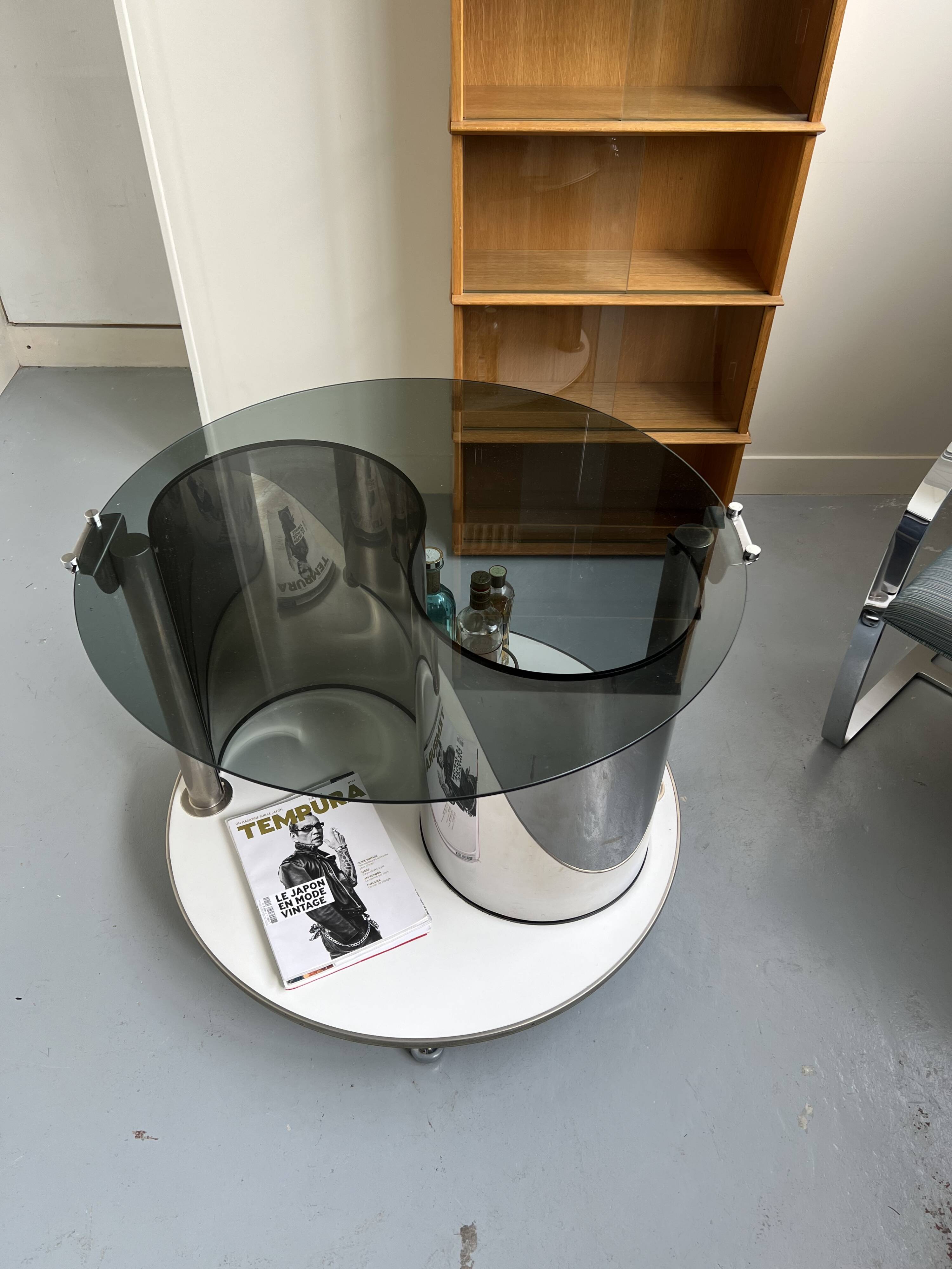 Vintage metal and smoked glass coffee table on casters bar