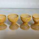 Four yellow spiral spring egg cups