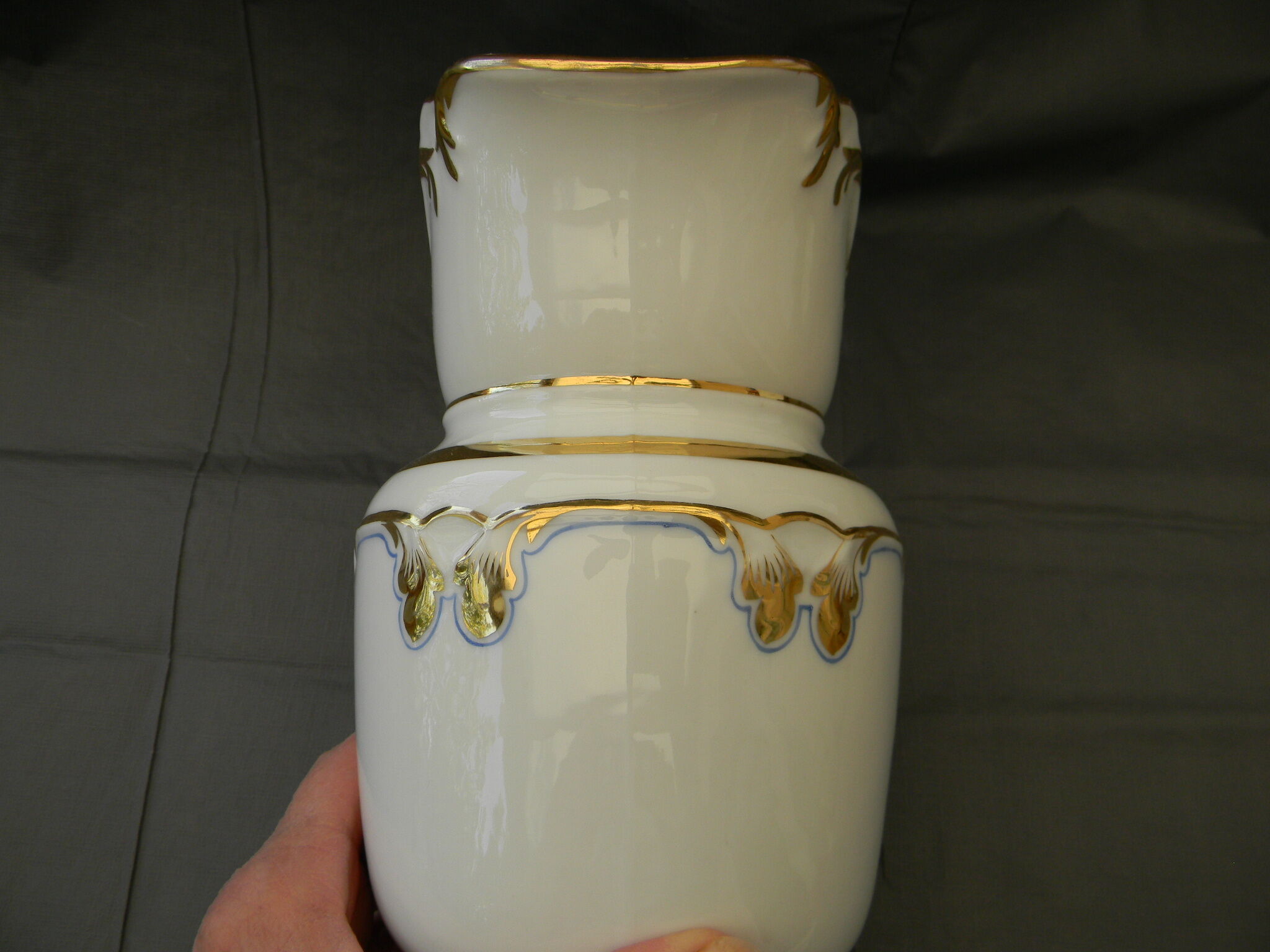 Milk jug or antique pitcher in white and gold porcelain.