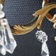 Pair of gilt bronze wall sconces with crystal pendants.