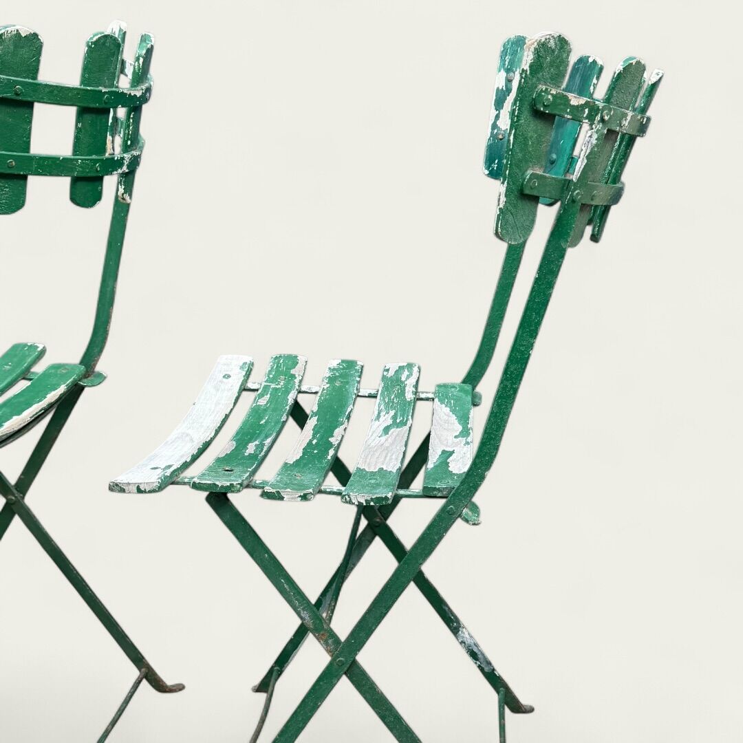 Pair of original patinated folding Parisian bistro chairs.