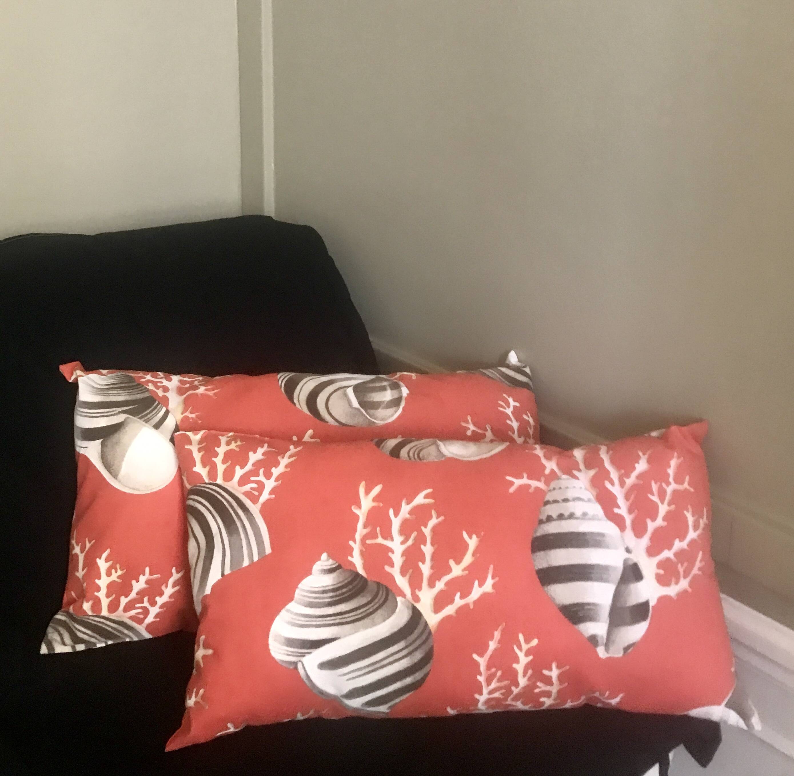 Coral and shell cushion