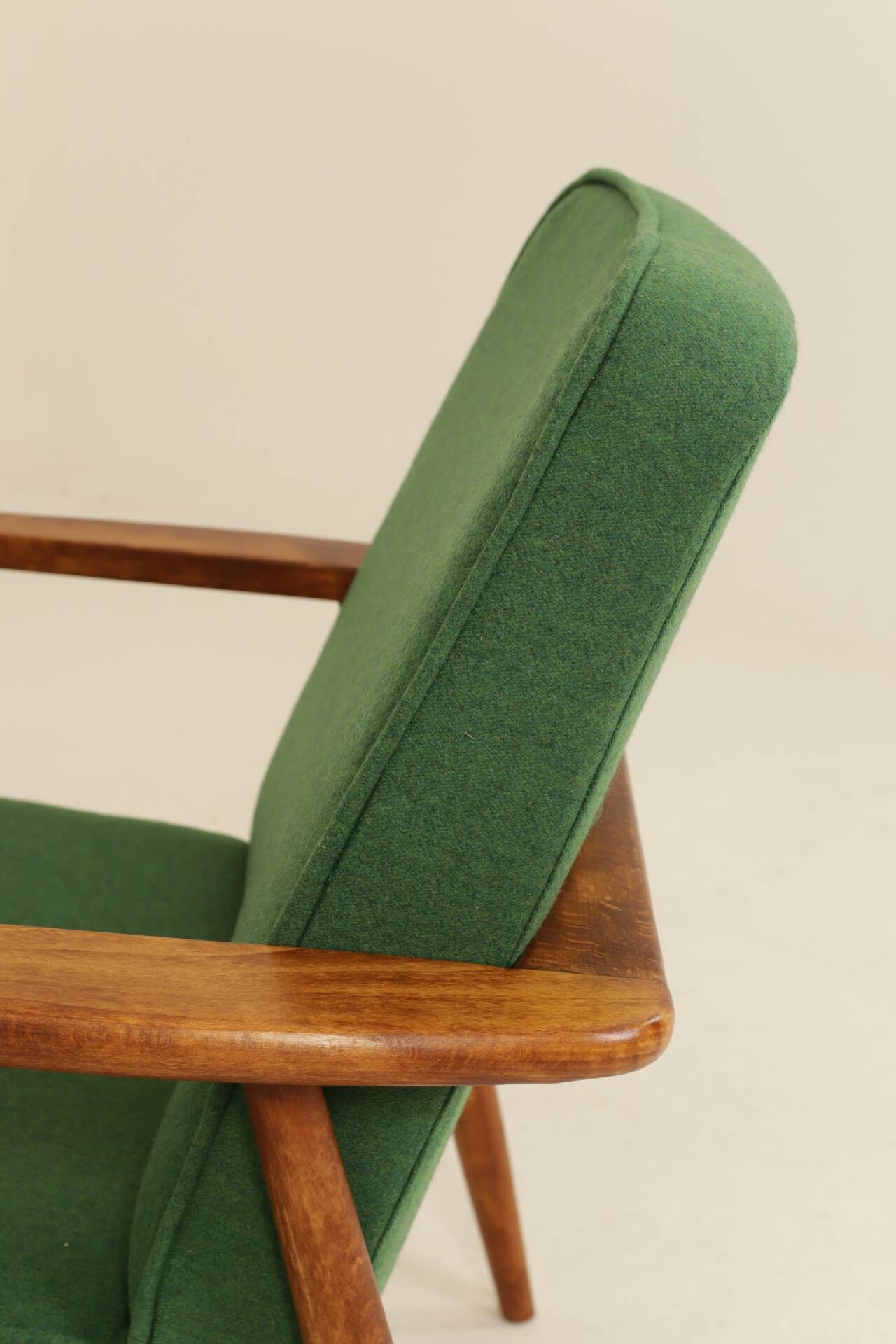Scandinavian modern chair in green wool, vintage wooden armchair.