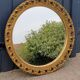 Round neoclassical style mirror in wood and gilded stucco from the 1950s