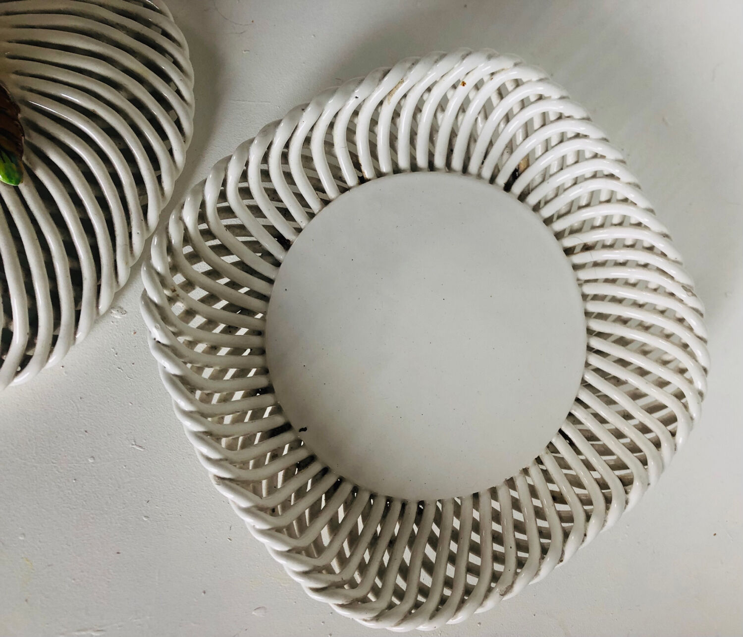 Covered basket in woven ceramic and fruit slip.