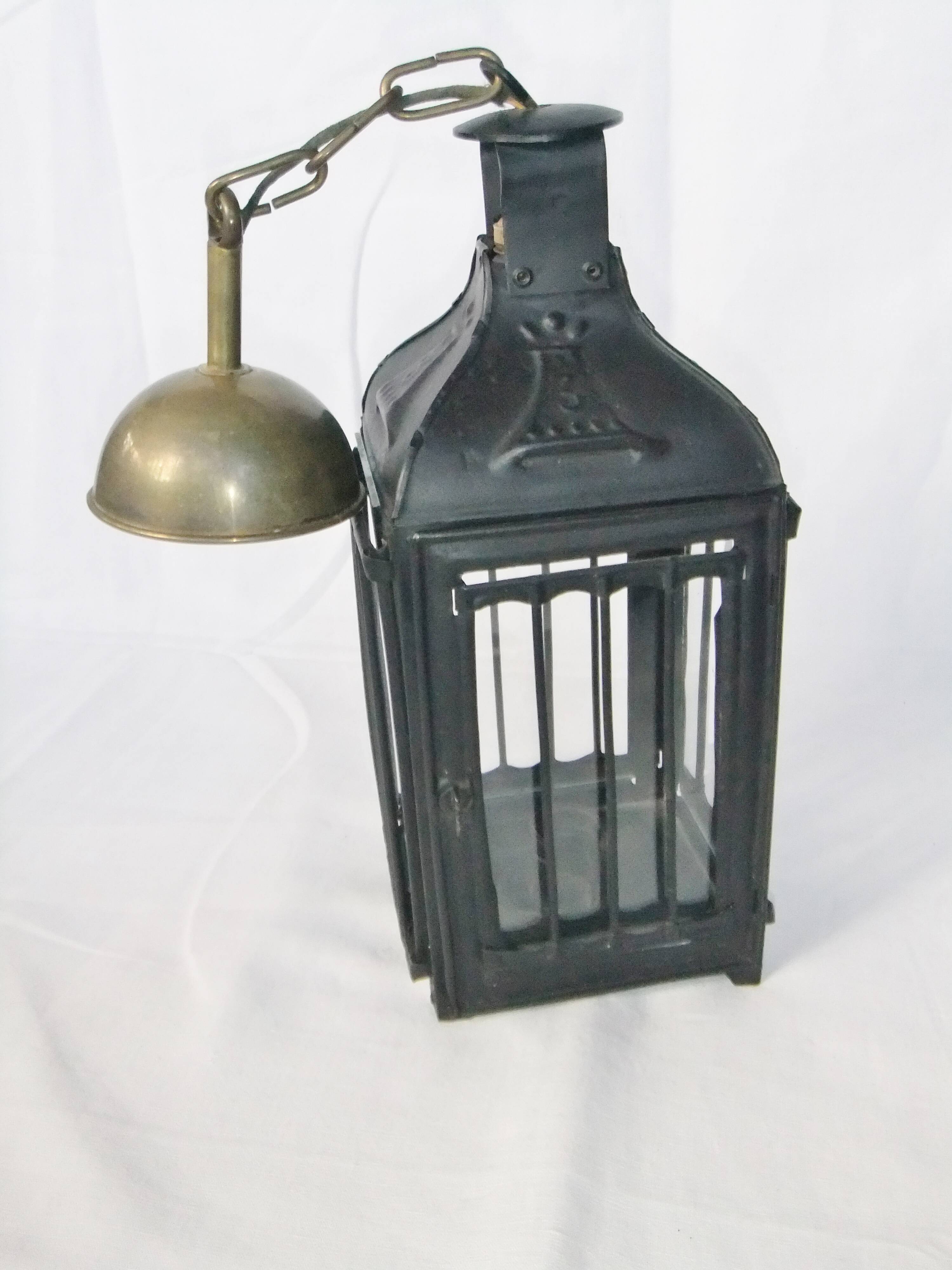 Old chandelier hanging lantern with candle in sheet metal