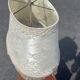 Two-armed hot water bottle lamp in silver metal with fringed fabric shade