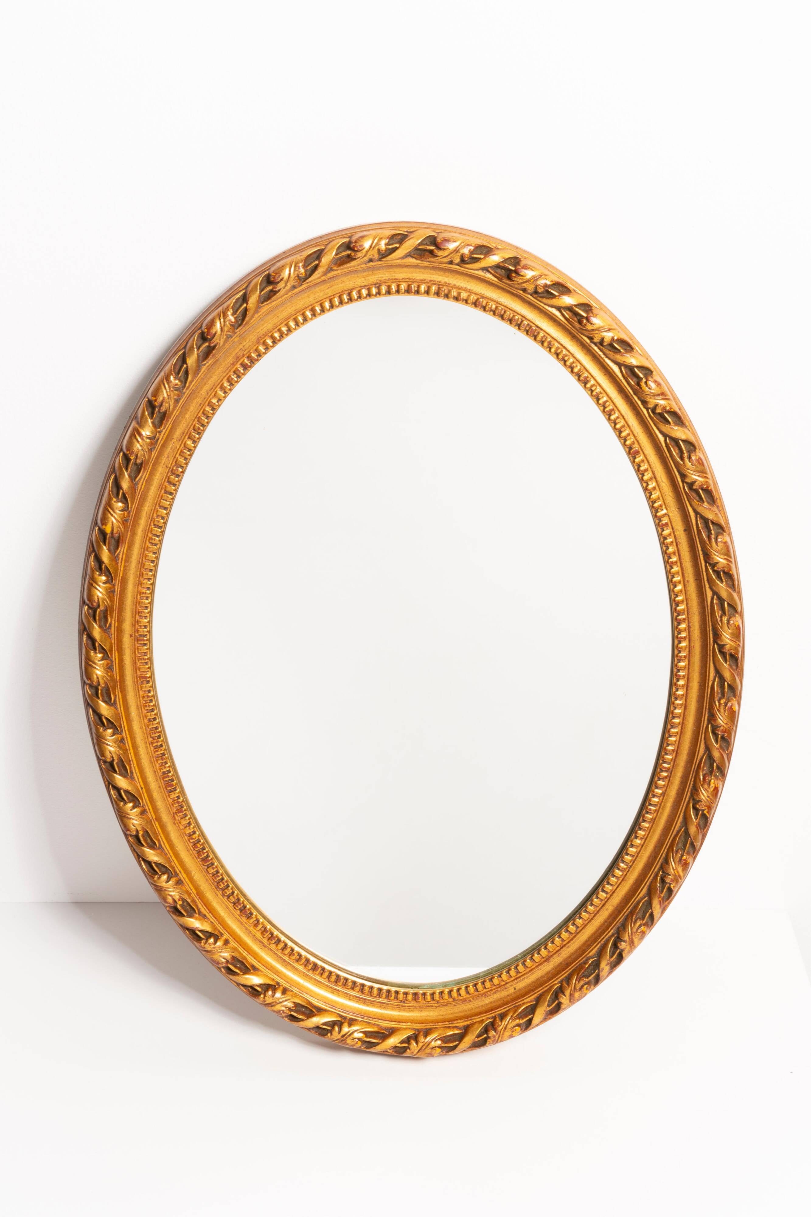 Decorative oval mirror with a floral frame, Italy, 1960s.