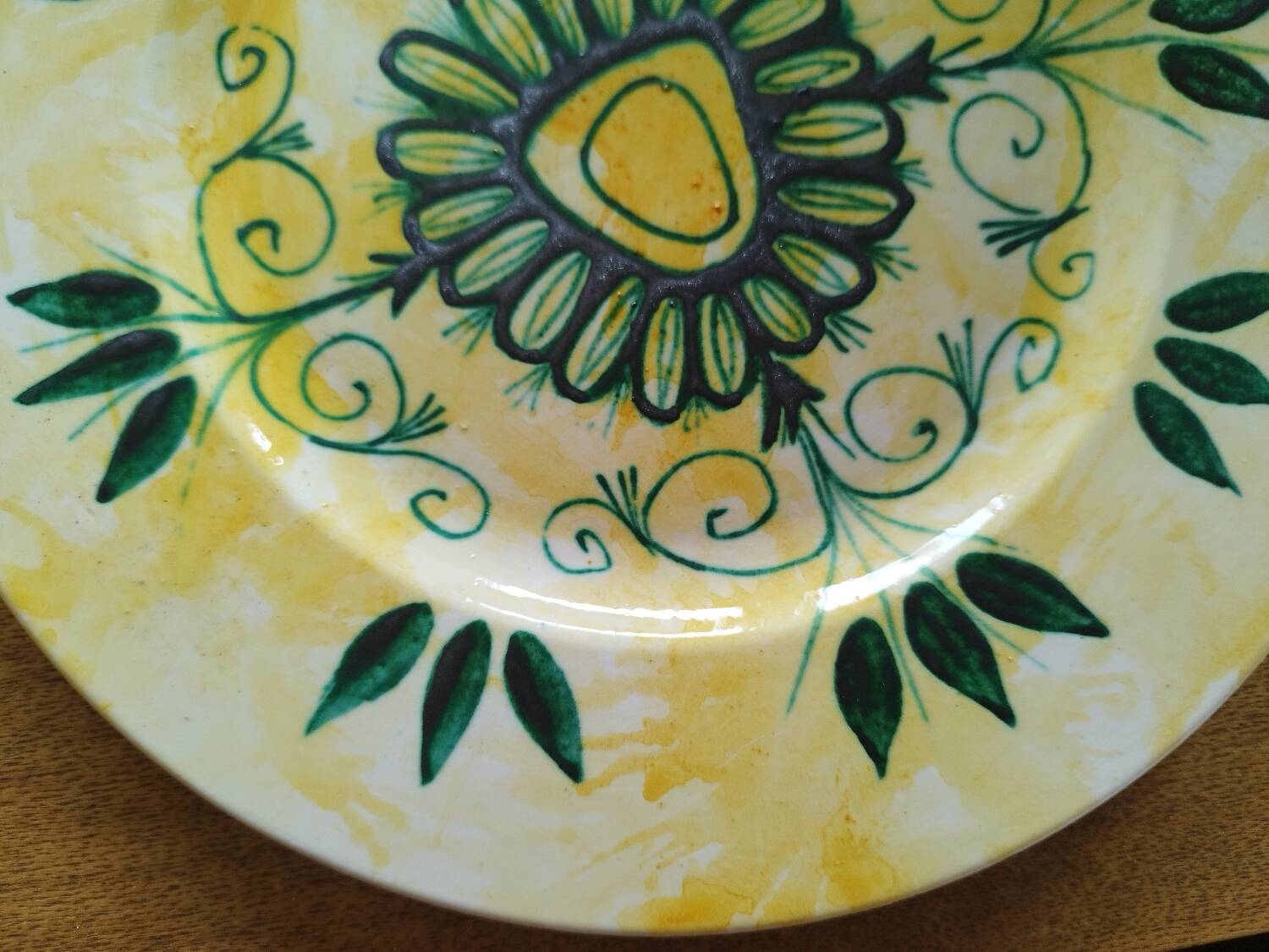 Plate decorated with yellow and green flower, signed Kerbigot.