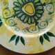 Plate decorated with yellow and green flower, signed Kerbigot.