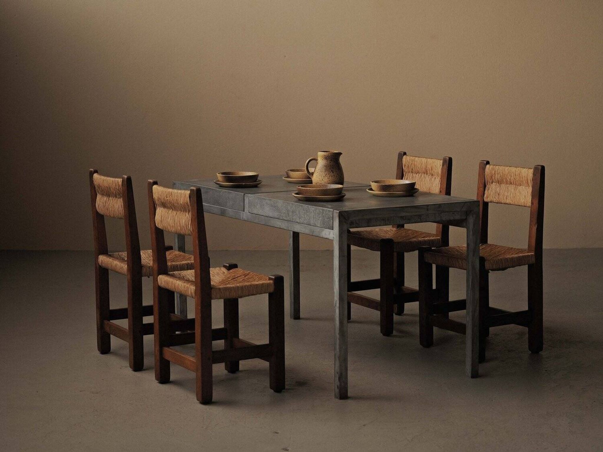 Set of four modernist chairs in oak and straw, France, circa 1960.