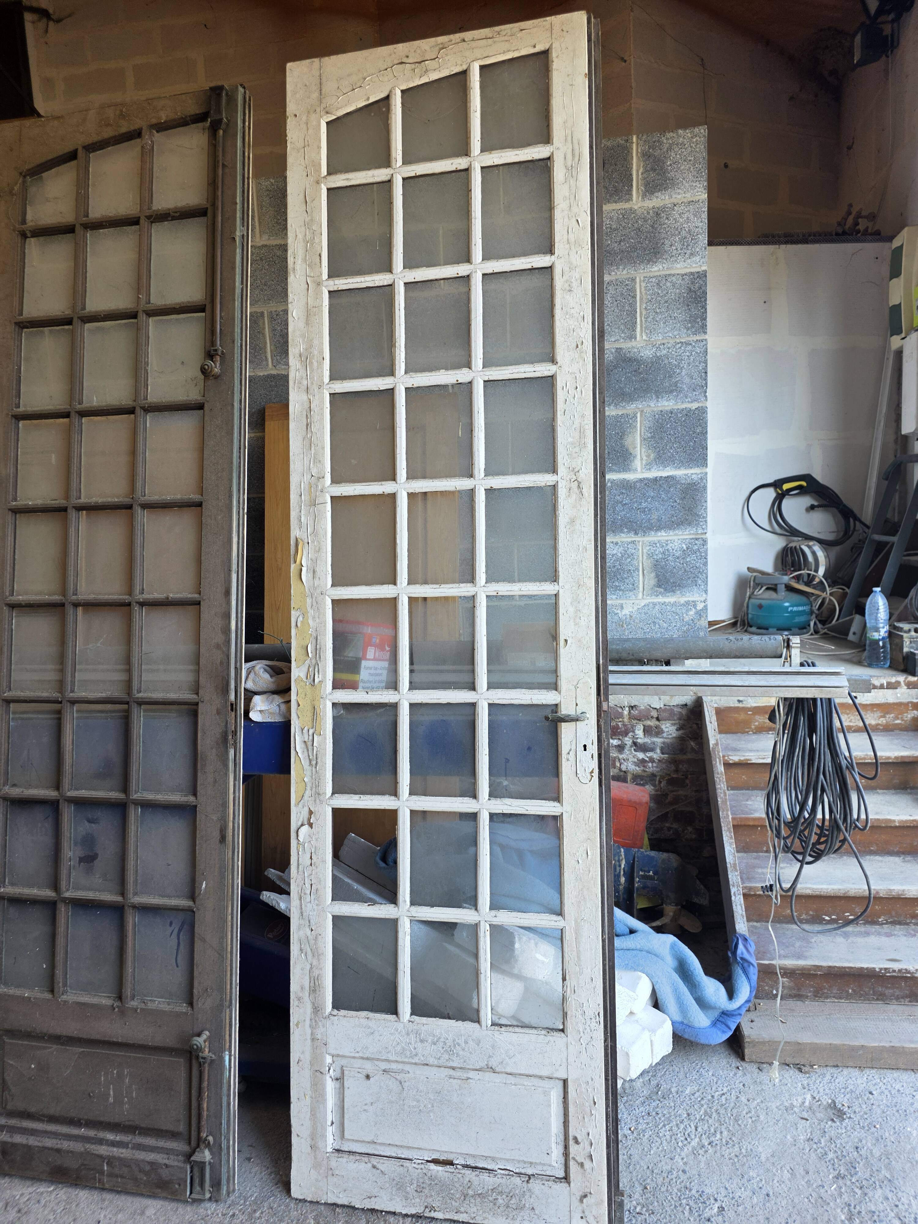 Two pairs of solid oak doors with small panes.
