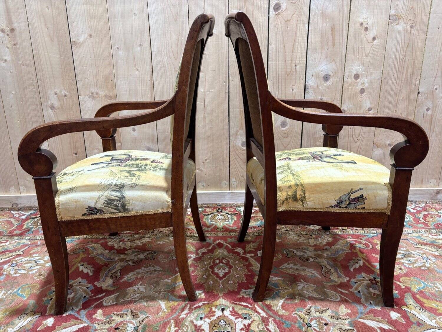 Pair of 19th-century armchairs with a scrolled back