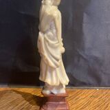 Soapstone sculpture on obsidian base of a Buddhist.