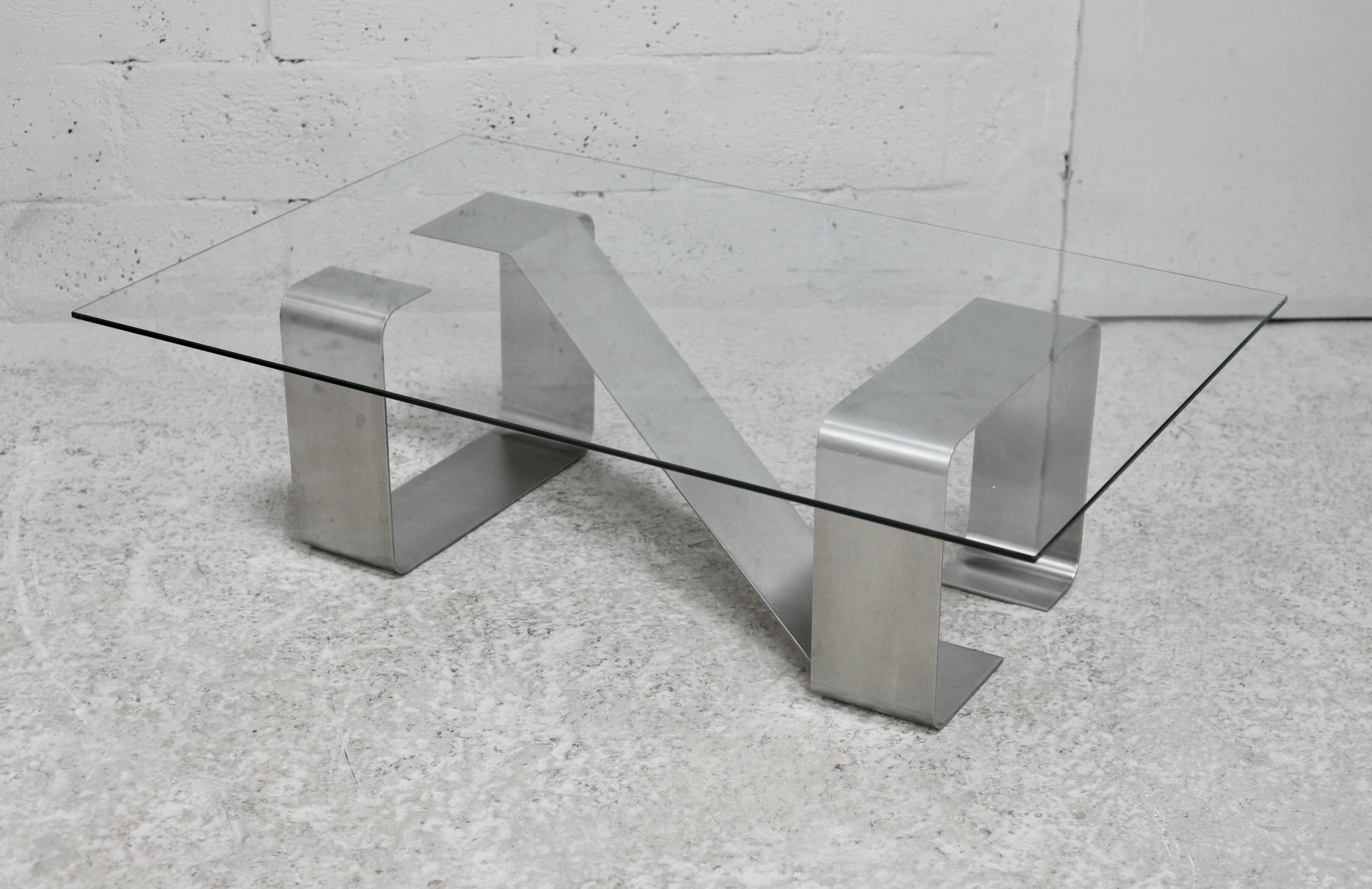 Coffee table with "kinetic" steel base and glass slab. Circa 1970.
