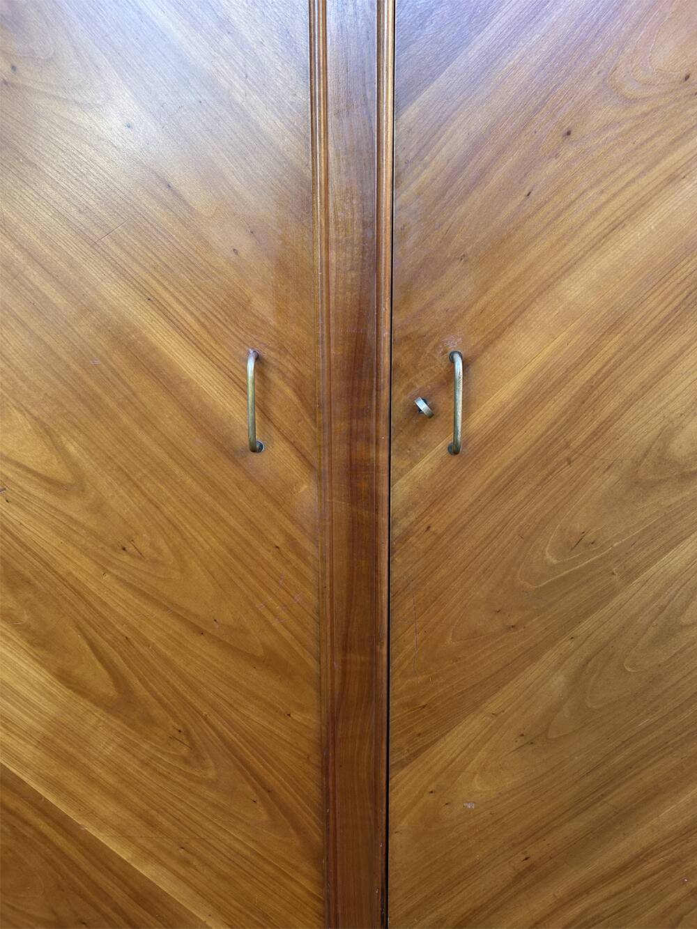 Mid-century wardrobe from the 1960s in wood, with a chevron front and tapered legs.