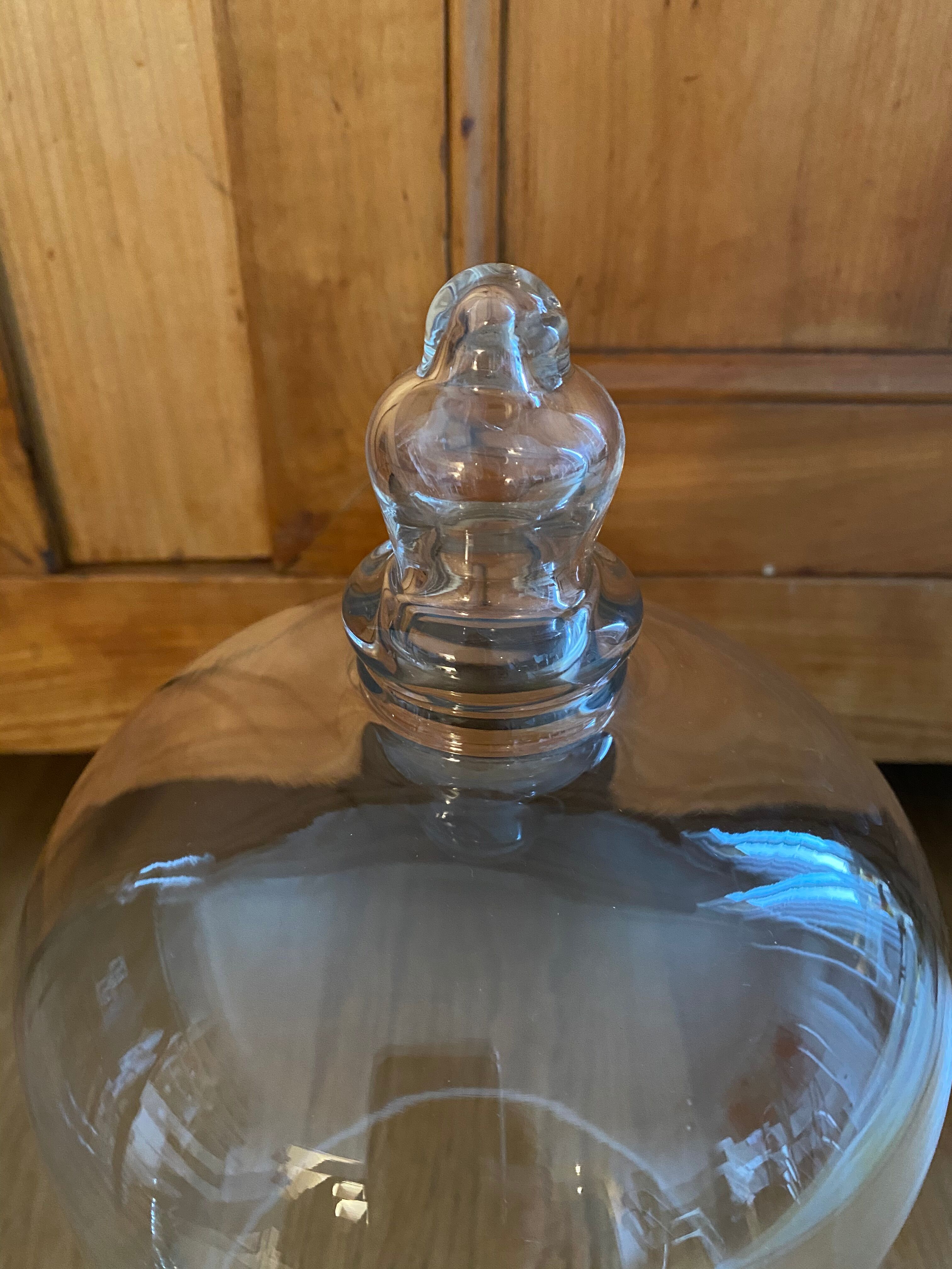Large old glass bell and its wooden base