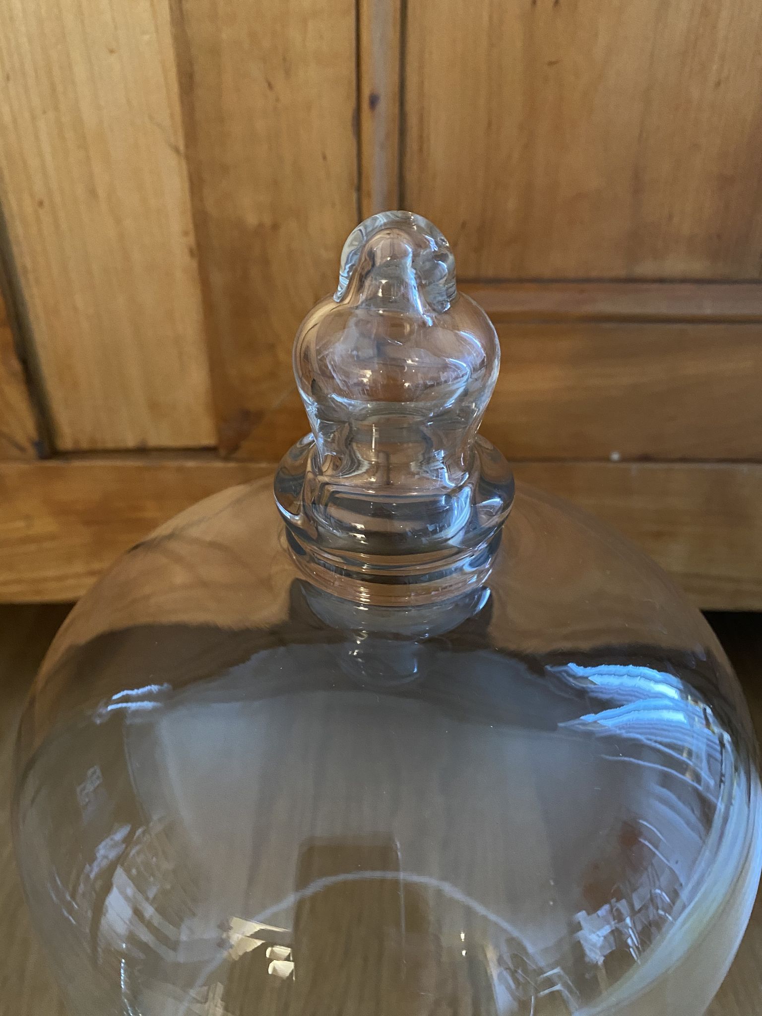 Large old glass bell and its wooden base
