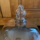 Large old glass bell and its wooden base