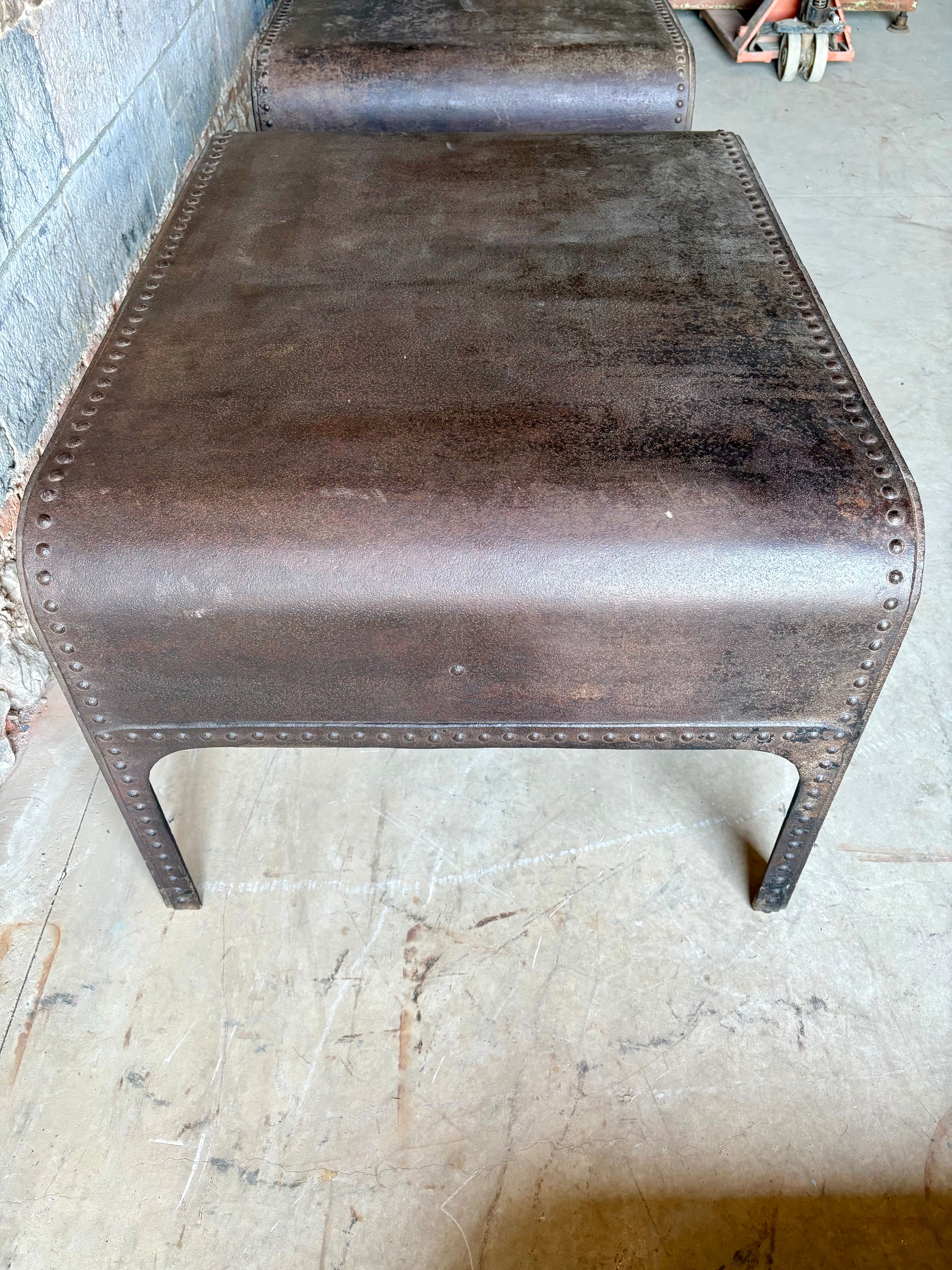Pair of large riveted metal industrial tables