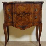 Louis XV style commode with a projection in marquetry.