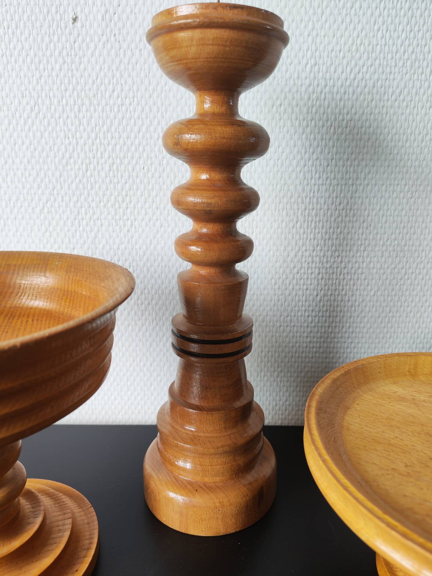 Vintage decor trio: candlestick and light wood bowls in Scandinavian style.