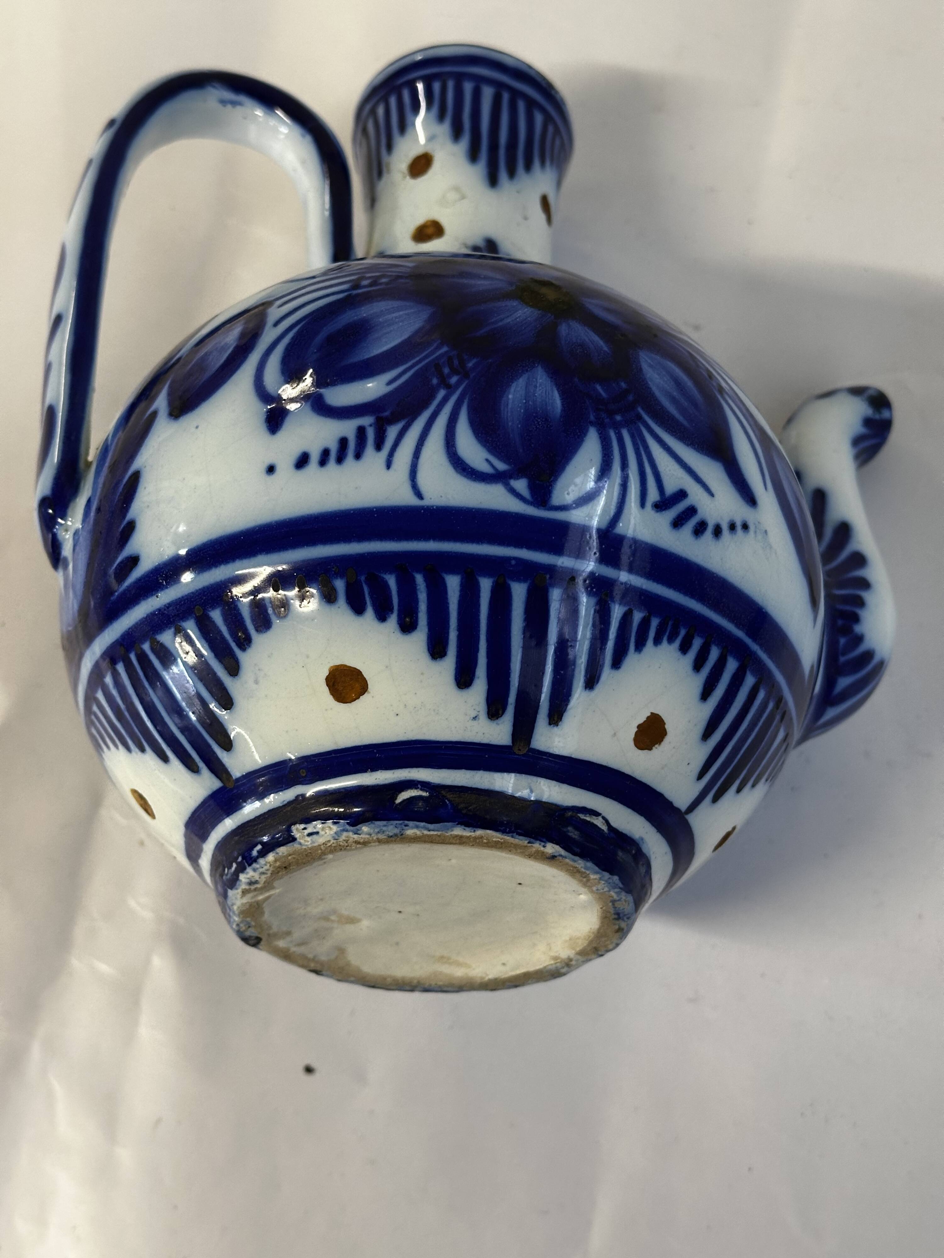 Glazed ceramic carafe with floral decoration