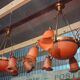 Pair of Art Nouveau style chandeliers in bronze and orange glass paste.