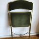 Set of three vintage green folding chairs