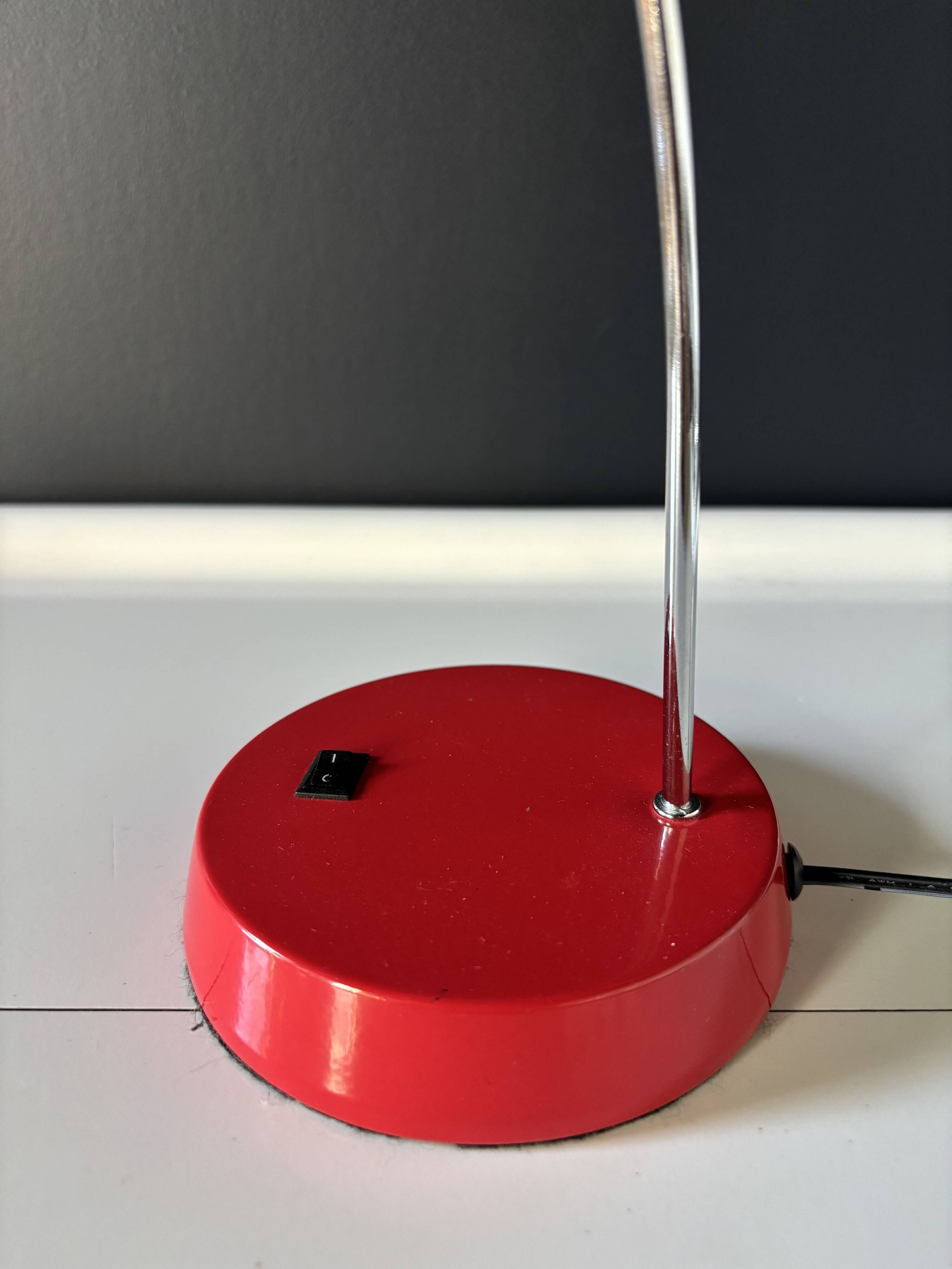 Vintage red lamp with a curved arm