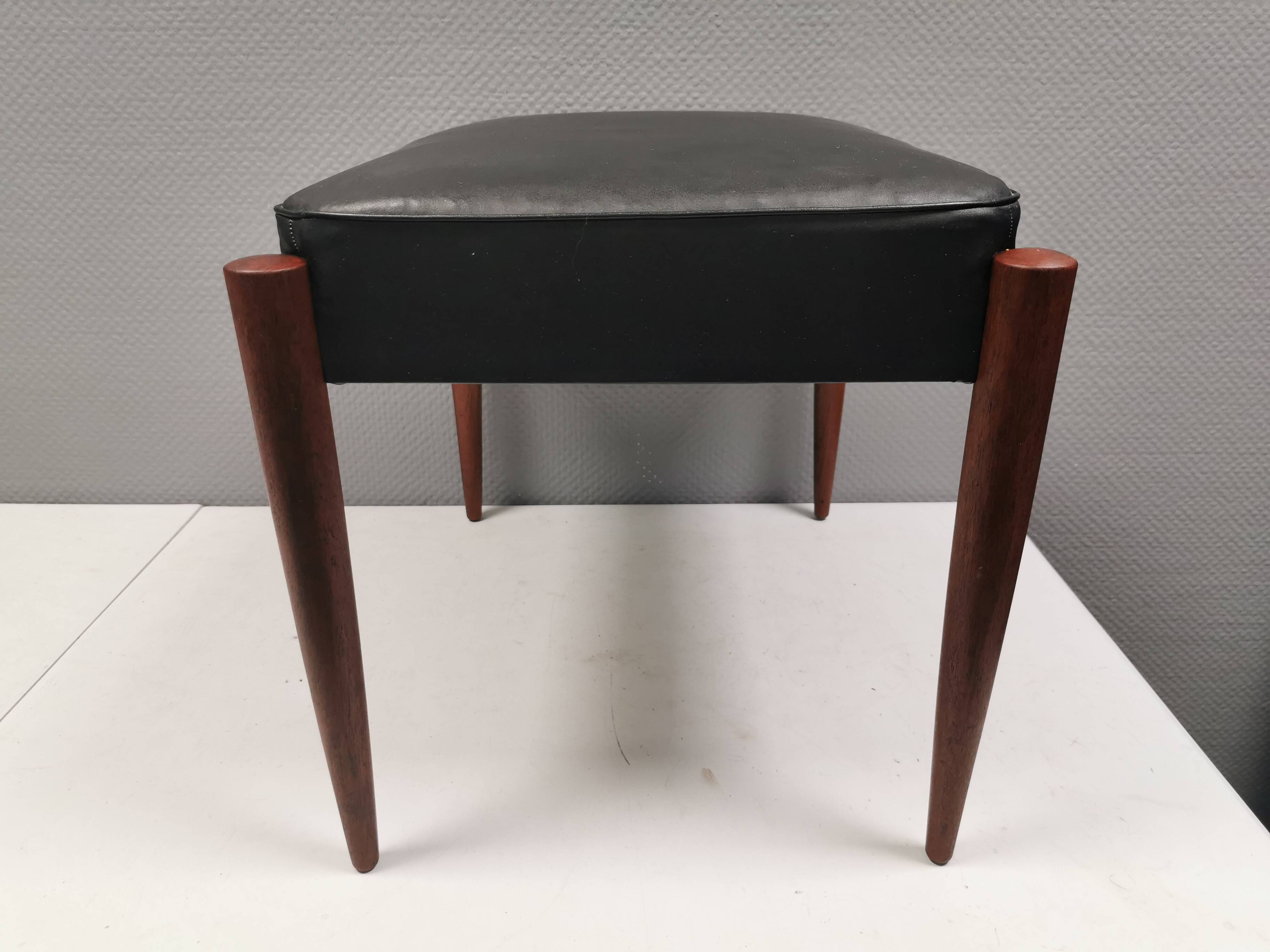 Footstool with teak wood legs and black skai (imitation leather) 1970s