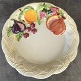 Vintage plate in ceramic enamelled decoration of fruits in relief