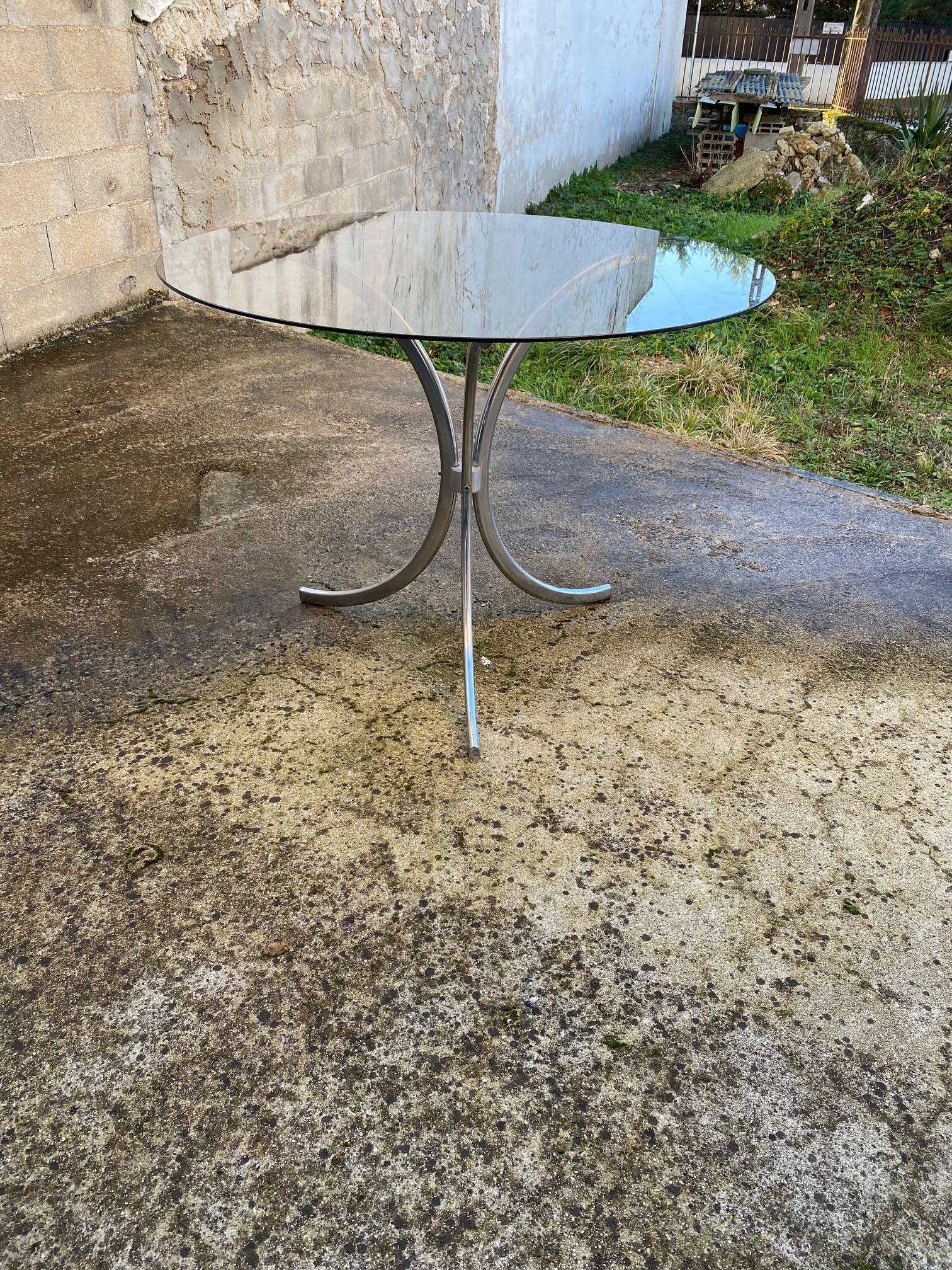 Table with chrome metal legs and smoked glass top.