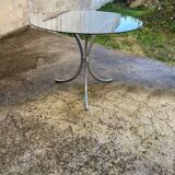 Table with chrome metal legs and smoked glass top.