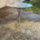 Table with chrome metal legs and smoked glass top.