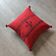 Red Berber cushion with cotton pompom