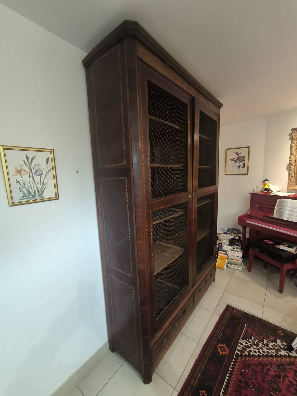 Library in marquetry with a grille from the Louis XVI period.