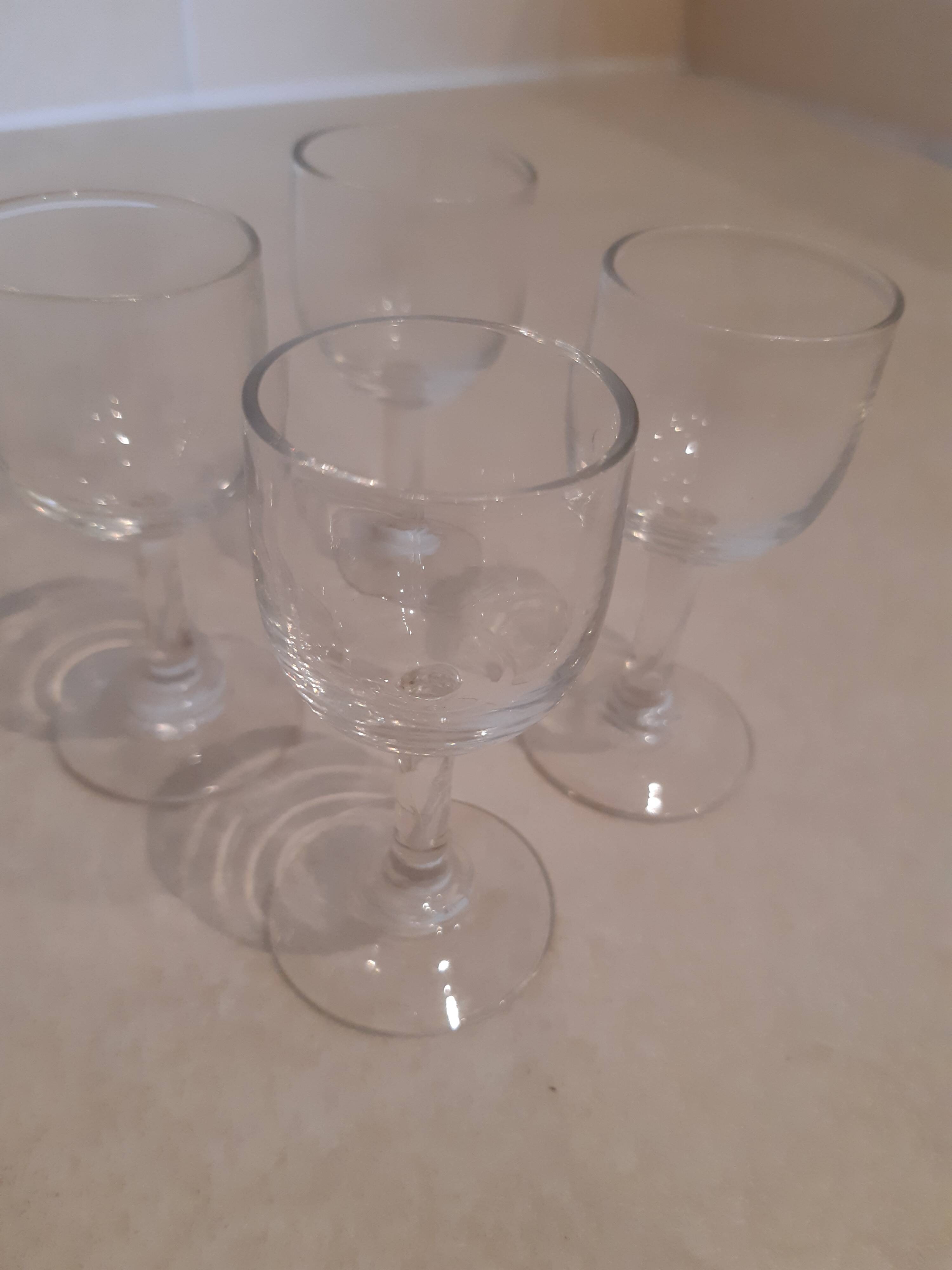 Set of 4 small stemmed glasses for strong alcohol.