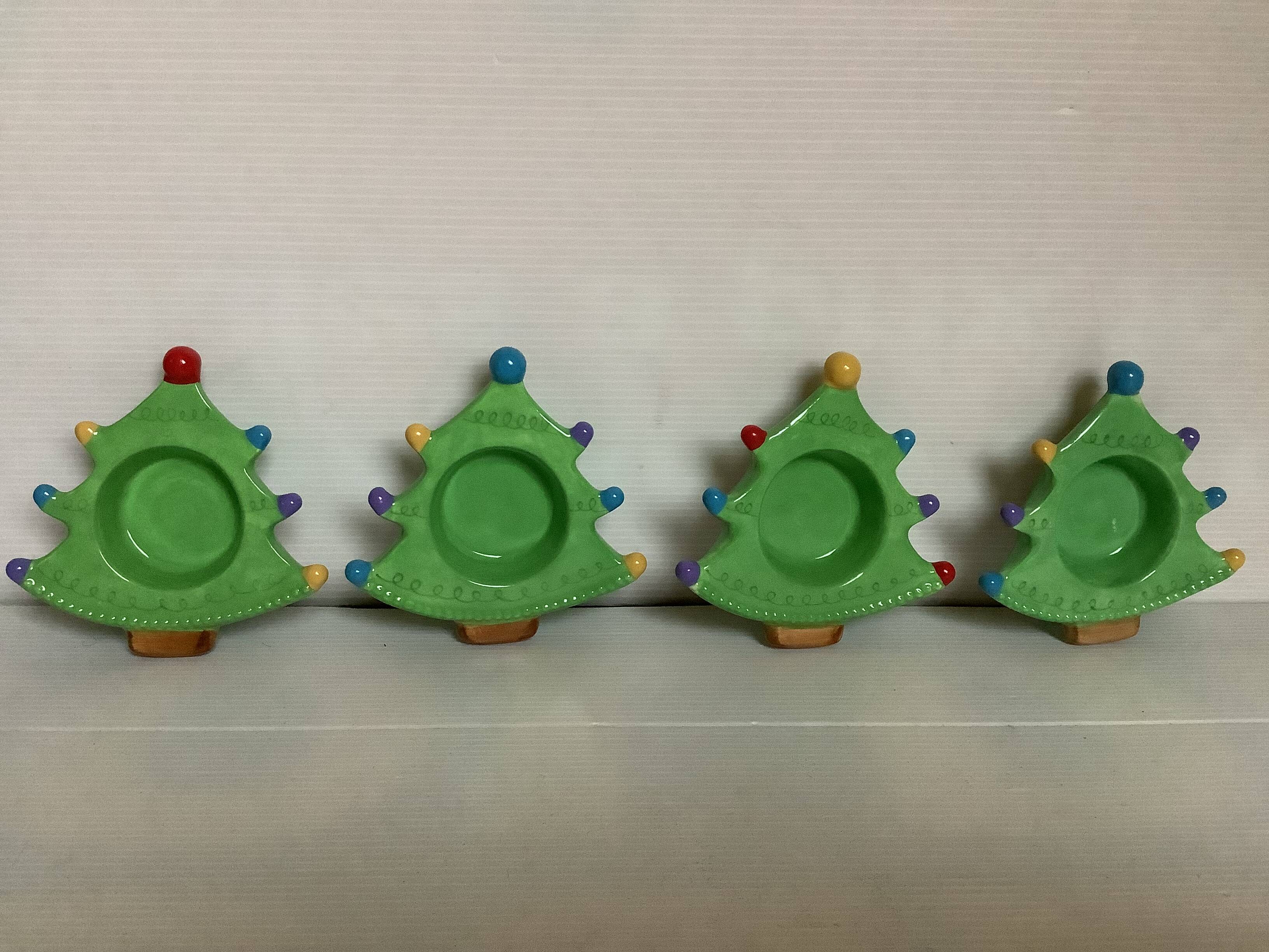 Four Christmas tree-shaped candle holders
