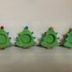 Four Christmas tree-shaped candle holders
