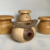 Four solid turned wooden vases