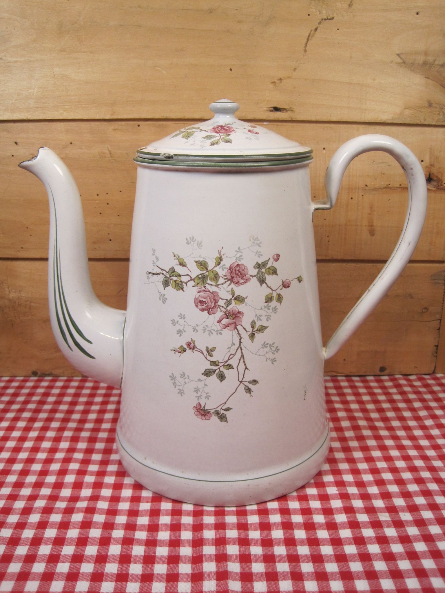 Old coffee maker in enamelled sheet metal brand bb 1900s , decoration of roses , kitchen utensils