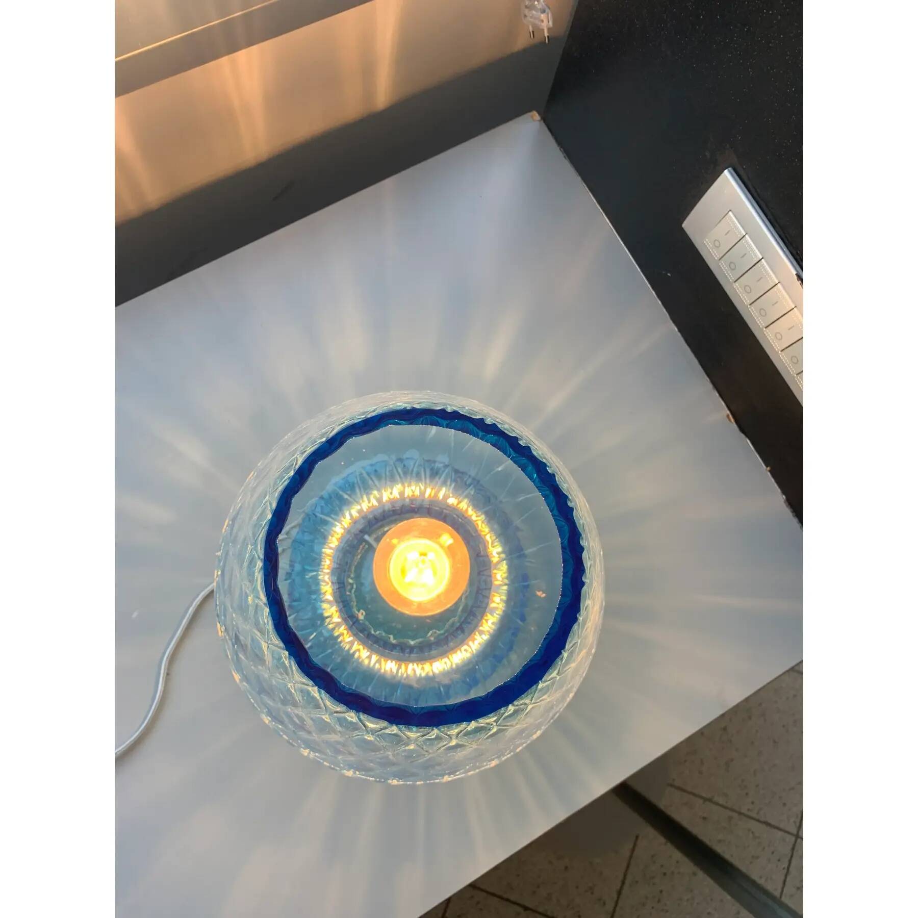Light blue Murano-style glass with a balloton lamp.