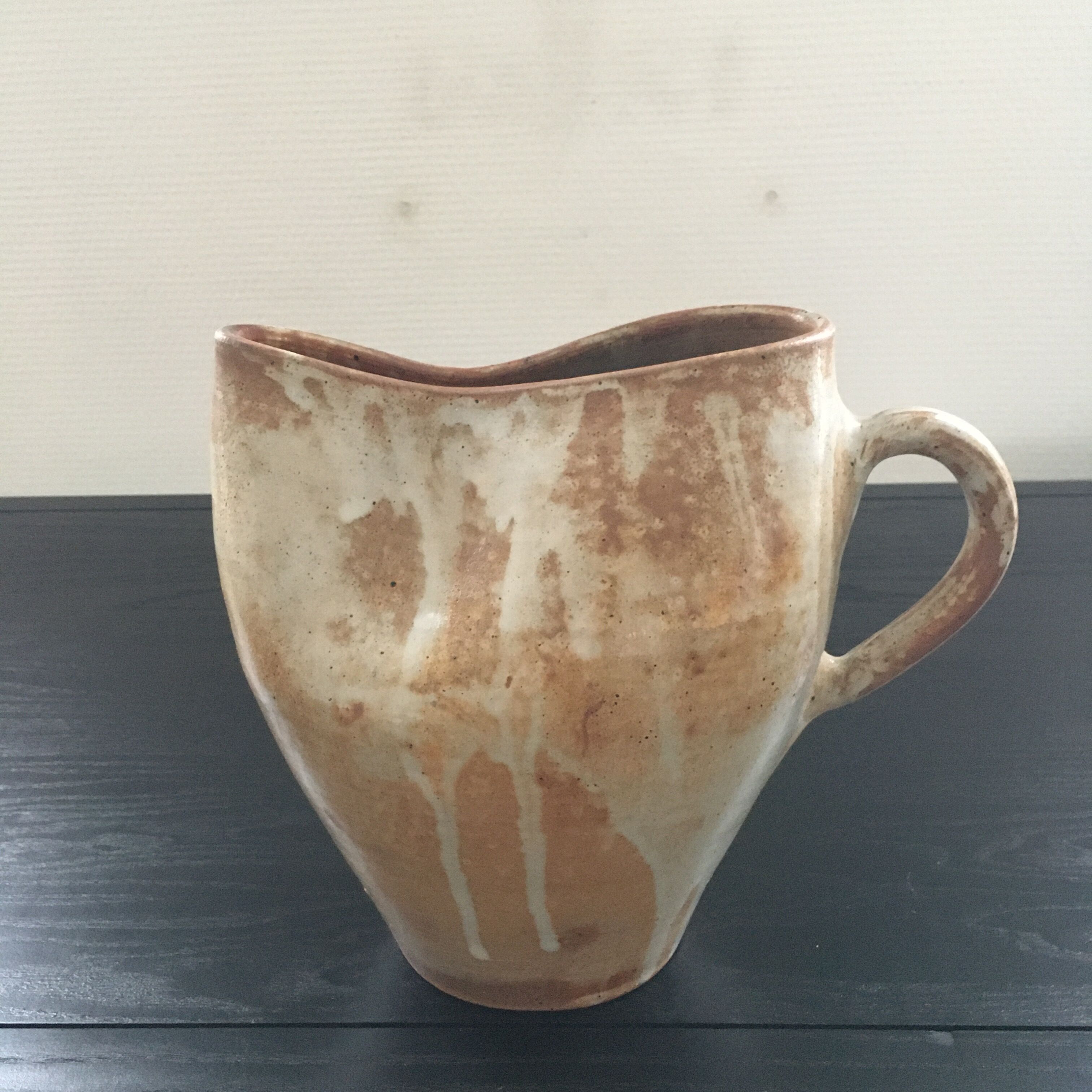 Beige stoneware pitcher with white drips