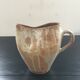 Beige stoneware pitcher with white drips