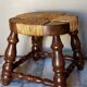 Low vintage regional stool in solid wood with straw top
