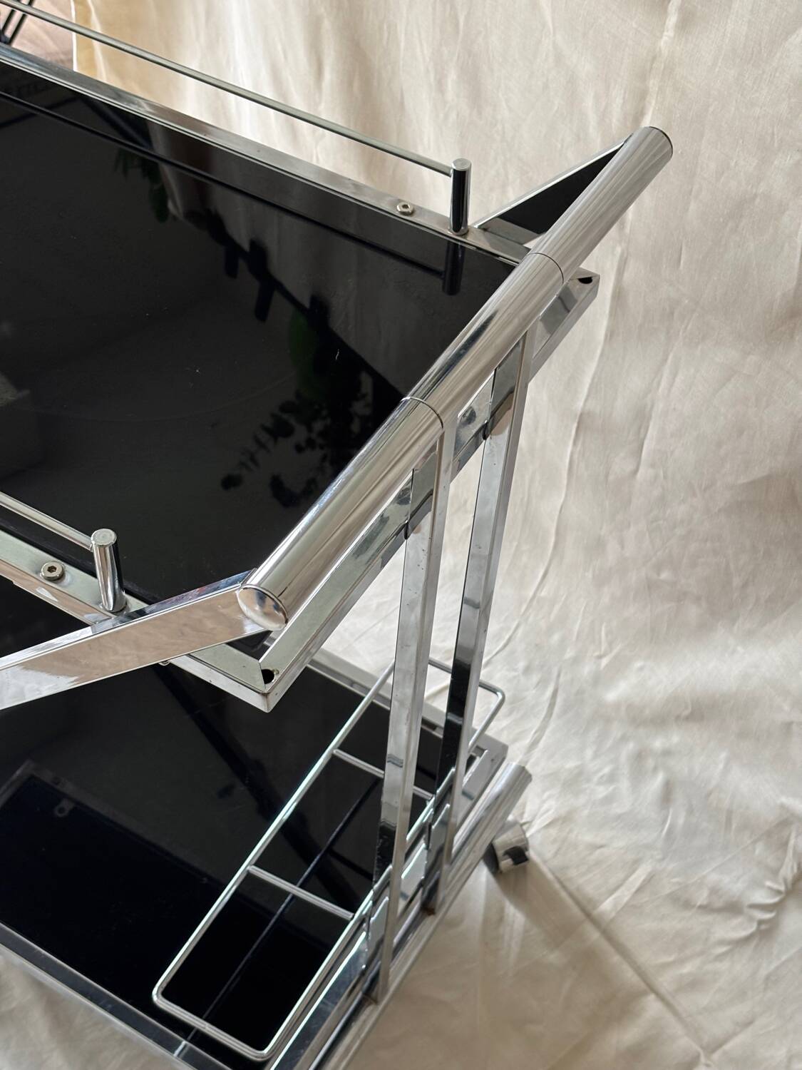 Modernist serving trolley in chromed metal and black smoked glass