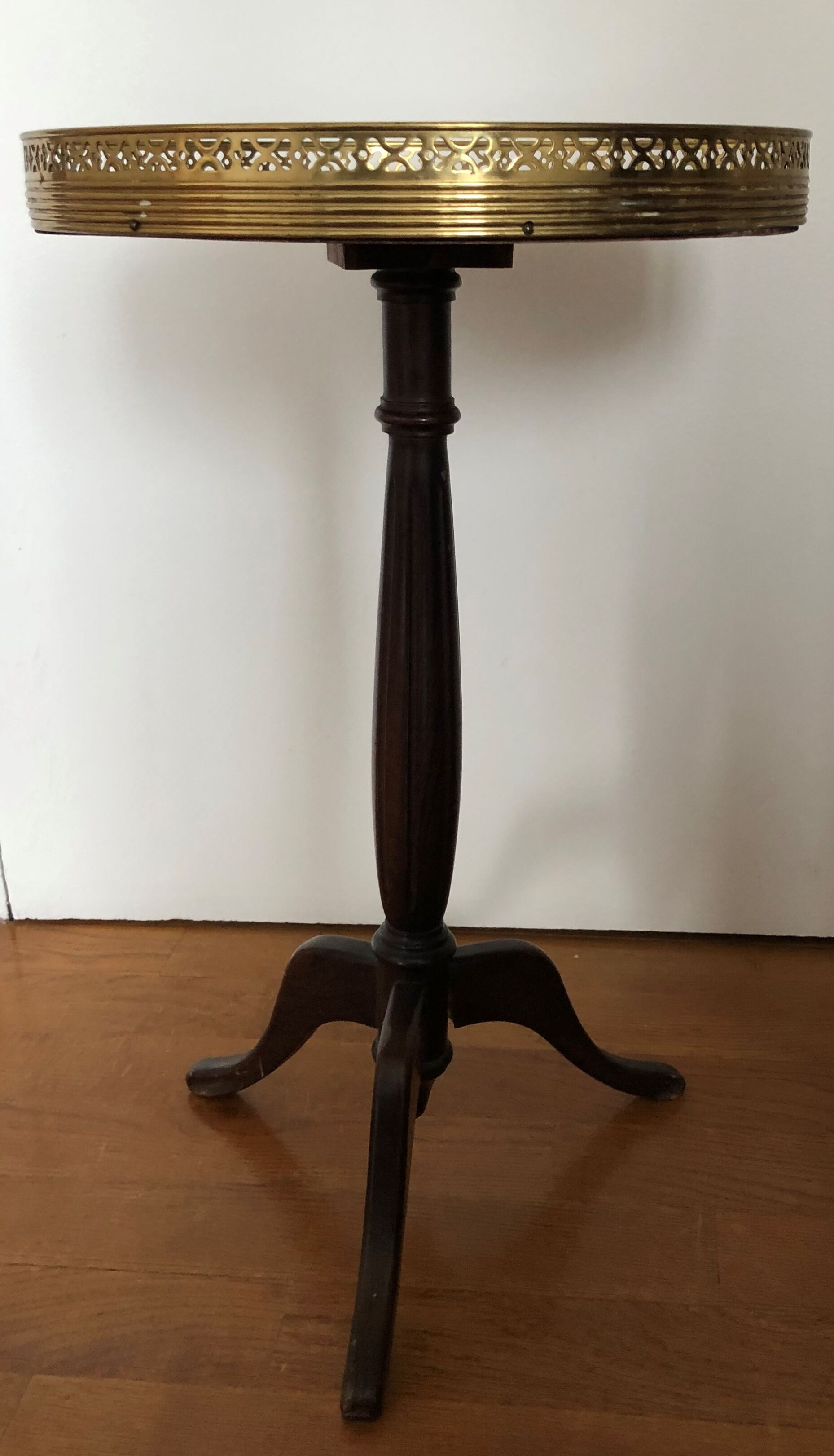 Wooden pedestal table on marble