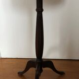 Wooden pedestal table on marble